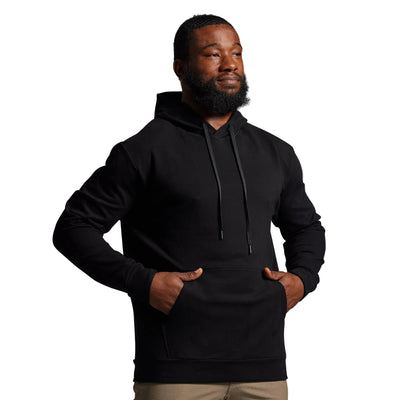 Man wearing a black hoodie against a gray background