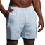 Light blue shorts worn by a person on a plain background