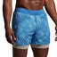 Blue swim shorts worn by a person on a plain background