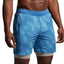 Blue athletic shorts worn by a person on a gray background