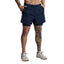 Person wearing navy blue athletic shorts on a gray background