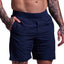 Navy blue shorts worn by a person with tattoos on a light gray background