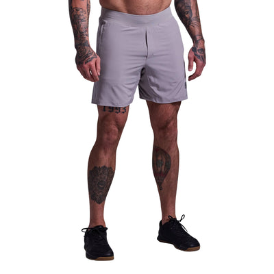 Person wearing light gray athletic shorts on a plain background