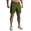 Person wearing green shorts on a plain background