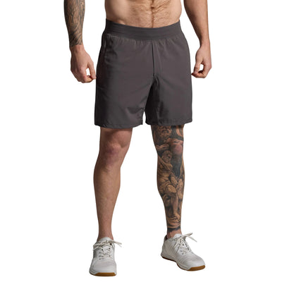 Person wearing gray shorts on a plain background