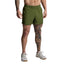 Person wearing green shorts on a plain background