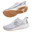 A pair of athletic sneakers shown from two angles: the top view displays the white mesh upper with a metallic silver side logo and heel accent, while the bottom view shows the sole with a white midsole, a textured brown gum outsole, and a silver heel insert. The shoes are set against a solid light gray background.