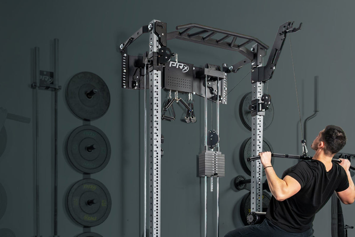 Person using a pull-up bar in a gym setting with weights in the background