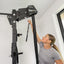 Person using a pull-up bar in a home setting