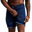 Person wearing blue denim shorts on a plain background