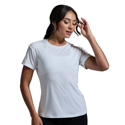Woman wearing a plain white t-shirt against a light gray background