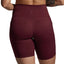 Maroon athletic shorts worn by a person on a gray background