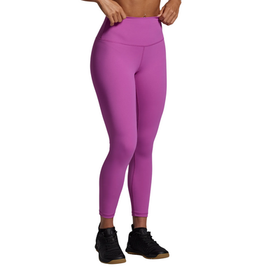 Person wearing bright pink leggings on a gray background