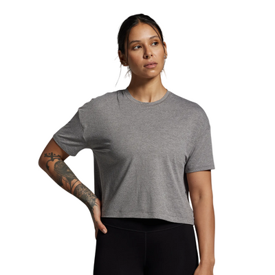 Woman wearing a gray t-shirt against a plain background