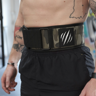 Person wearing a black and camouflage weightlifting belt with a logo.