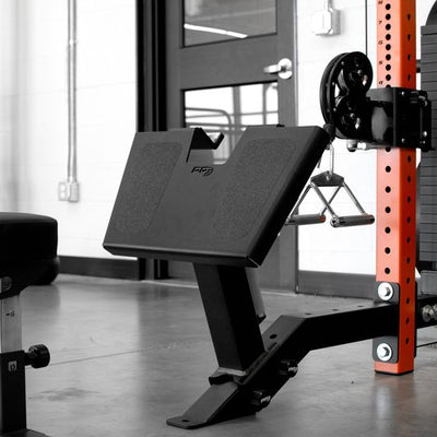 Gym equipment including a weight bench and weight plates in a gym setting.