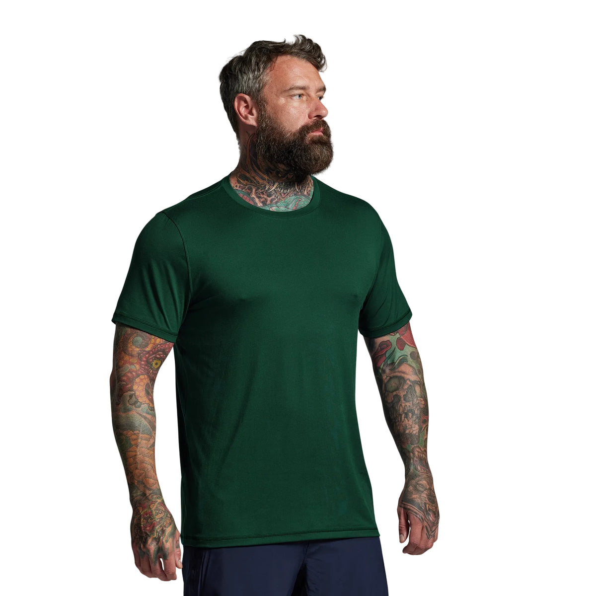 Man wearing a green t-shirt against a gray background