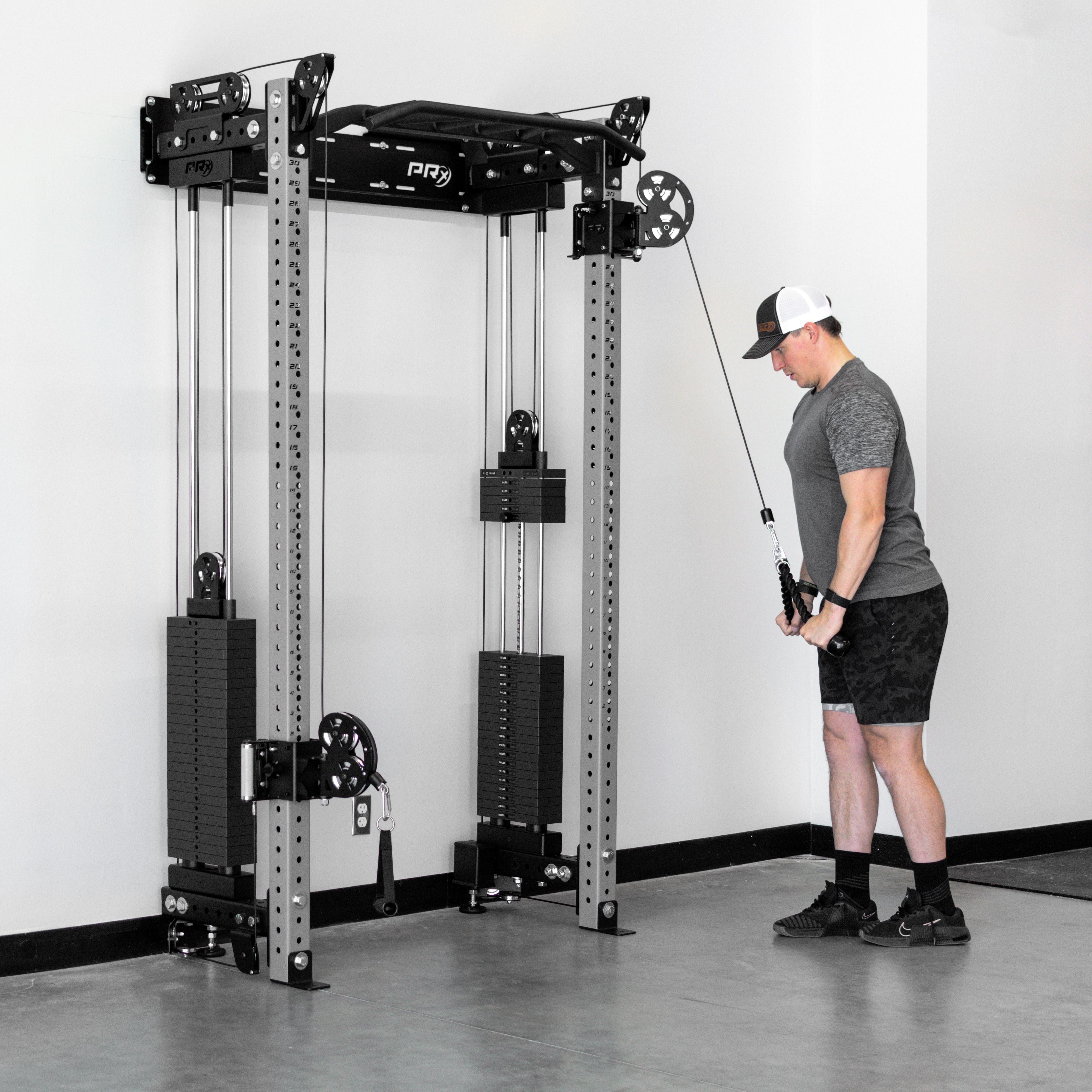 Person using a cable machine in a gym setting with a white wall background