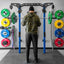 Person preparing to lift weights on a barbell in a gym setting with colorful weight plates.