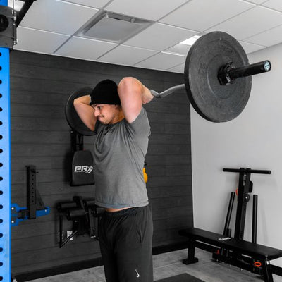 Person lifting a barbell in a gym setting