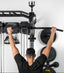 Person using a pull-up bar on a PRx fitness system against a white wall.