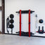 stored red folding full cage with gym equipment stored near on the wall