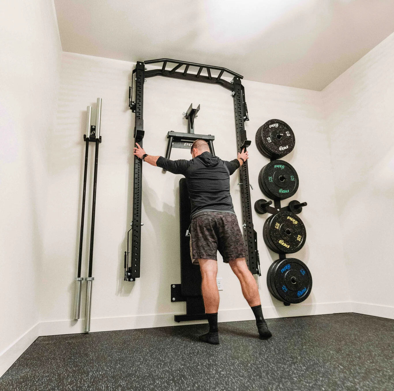 Person folding a PRx folding rack on the wall