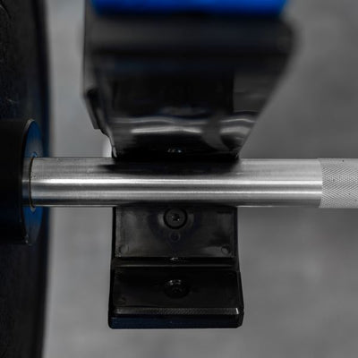 Close-up of a barbell with weight plates on a blurred background