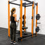 Woman doing curls with Ripcord Low Pulley mounted to Build Limitless 6-Post Rack.