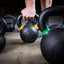 Athlete grabbing powder coated PRx kettlebell