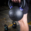 Athlete holding PRx powder coated kettlebell