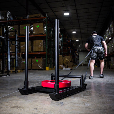 PRx athlete pulling loaded sled with harness